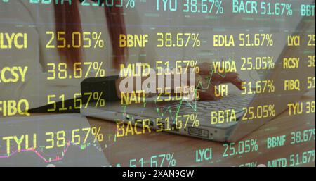 Image of stock market data processing against mid section of a woman using laptop Stock Photo