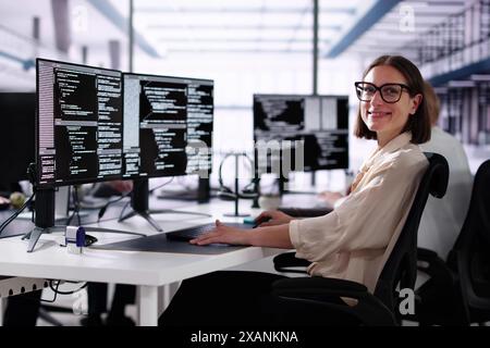 African American Coder Using Computer At Desk. Web Developer Stock Photo