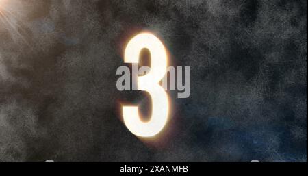 Large glowing number three is centered against dark, textured background Stock Photo