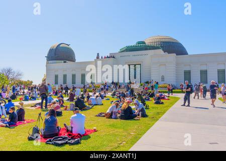 Los Angeles, California - April 8, 2024: Crowd at Griffith Park, observing a solar eclipse with the iconic Griffith Observatory in the backdrop Stock Photo