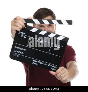 Making movie. Man with clapperboard on white background Stock Photo