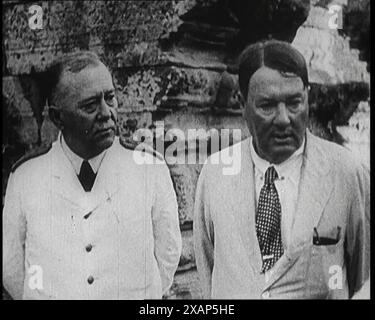 Publisher Alfred Harmsworth, 1st Viscount Northcliffe, Talking to Another Man by a Ruin, 1922. From &quot;Time to Remember - Sitting Still And Going Slowly&quot;, 1922 (Reel 4); a review of events in 1922 including Irish Troubles, war between Greece and Turkey and developments in aviation and radio. Stock Photo