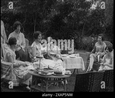 A Group of Female Civilians Drinking Tea and Eating Cakes in the Garden, 1926. From &quot;Time to Remember 1926 - Short Sharp Shower&quot;- Reel 1; a documentary about 1926 - General Strike, international politics, dancing, weather and record breaking feats. Stock Photo