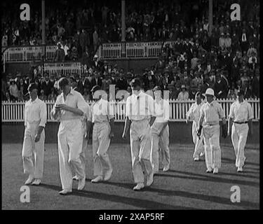 The English Cricket Team Coming Out to Play in Ashes Test in Front of a Large Crowd, 1929. 'England won the Ashes'. From &quot;Time to Remember -  1929 The Time Of The House At Bognor&quot; - Reel 1; a documentary about the world in 1929. Illness of King George V &amp; economic depression. Stock Photo