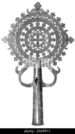 Cross used in processions, 1868. 'The Engraving of a metal cross is taken from one which was presented to Mr. Clements Markham, the geographer accompanying the [British] Abyssinian expedition, by the priest of the church at Chaffa. The cross, which is of a design denoting considerable antiquity and Abyssinian manufacture, is of copper, and is made so as to fit into a pole for use by the priest, and in processions. It consists of four concentric circles, the inner one containing a Maltese cross, and the others having elaborately-worked patterns of alternate zigzags and Maltese crosses. The oute Stock Photo