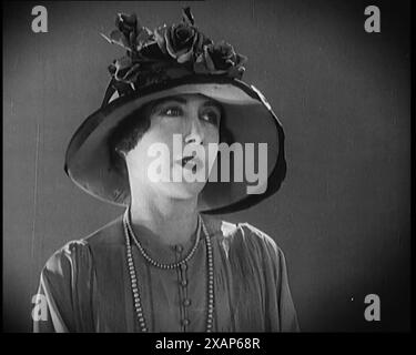 Female Civilian Modelling a Hat Decorated with Flowers, 1920s. From &quot;Time to Remember - Teenage Flapper&quot;, 1920s (Reel 1); a dcumentary about women's lives in the 1920s - great commentary by Joyce Grenfell. Stock Photo