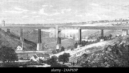 Lattice iron viaduct at the Ruisseau d'Alma, junction of the Montlucon and Limoges Railway, 1868. 'This is one of the largest of the engineering works in iron yet completed in France. The Montlucon and Limoges branch line recently opened by the Paris and Orleans Railway Company forms the shortest route from Lyons to Bordeaux. The district traversed by the line abounds in mineral wealth, and not the least extraordinary feature is that the coalfields are imbedded in solid granite, and great expense has been consequently incurred in the construction of the line, it being necessary to blast throug Stock Photo