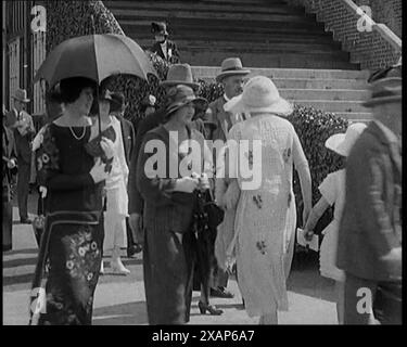 Civilians Walking Outdoors Wearing Evening Outfits and Hats, 1920s. From &quot;Time to Remember - Teenage Flapper&quot;, 1920s (Reel 1); a dcumentary about women's lives in the 1920s - great commentary by Joyce Grenfell. Stock Photo