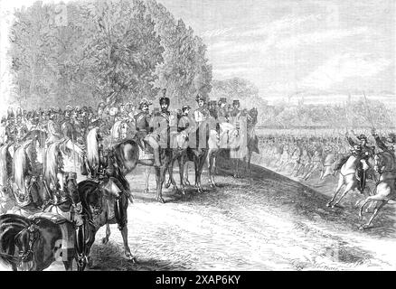 Review before the Emperor and the Prince of Wales in the Bois de Boulogne, Paris, 1869. '...the troops...comprised four brigades of cavalry, two regiments of artillery, and a couple of batteries, including the light cavalry of the Imperial Guard and of the first corps, chasseurs a cheval, guides, hussars, and cuirassiers. The Emperor came on the ground, accompanied by the Prince of Wales, the Prince Imperial, the Archduke of Austria, and Marshals Canrobert, Niel, and Regnault Saint-Jean d'Ang&#xe9;ly...On their arrival the trumpets sounded, arms were presented from one end of the plain to the Stock Photo