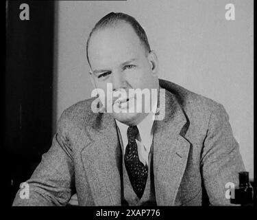 Male American Civilian Giving Expert Analysis in Court During the Lindbergh's Kidnapping Case Trial, 1930s. USA. "The crime of the century". '"After examining the genuine hand-writing of [Bruno Richard] Hauptmann, and the writing in the letters, there's no doubt, I believe, that this is the writer of the letters".' From "Time To Remember -  The Tough Guys", 1930s  (Reel 4); documentary film, mainly about life in depression- and gangster-hit America. Stock Photo