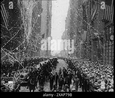 Crowd Watching a Parade, 1933. '...on Broadway there was more paper than rain. Everybody got a great kick out of it'. American aviator Wiley Hardeman Post (1898-1935) was the first pilot to fly solo around the world. From &quot;Time To Remember -  The Time Of The Monster&quot;, 1933  (Reel 2); documentary film about events of 1933, rise of Roosevelt and Hitler. Stock Photo