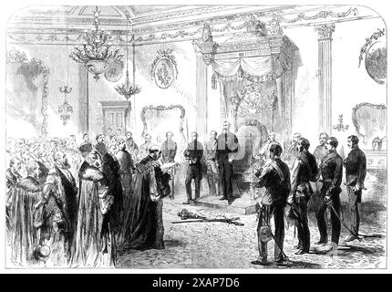 The Lord Lieutenant holding a State Reception at Dublin Castle, [Dublin, Ireland], 1869. 'The state reception...was attended by deputations from the Municipal Council and the University of Dublin, for the purpose of presenting addresses of congratulation on his appointment to the office of Lord Lieutenant. The deputations were received in the Presence Chamber. The Lord Lieutenant [John Poyntz Spencer, 5th Earl Spencer] appeared in full costume...First came the deputation from the Corporation, who wore their civic robes and were attended by the municipal officers, with their insignia. In receiv Stock Photo