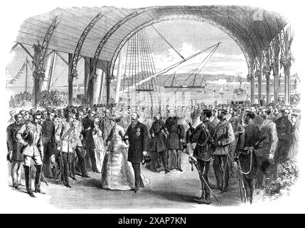 Visit of the Prince and Princess of Wales to Ireland: the Royal Party landing at the Victoria Wharf, Kingstown, 1868. '...a pavilion had been erected for the purpose of enabling the Royal visitors to set foot on the Irish shore under the most comfortable circumstances. This structure was commodious enough, but not very elegant. It was a wooden shed, built in the form of a boat-house...On each side were raised tiers of seats for the accommodation of a number of ladies and gentlemen who had secured tickets to witness the landing...The appearance of their Royal Highnesses was greeted with a loud Stock Photo
