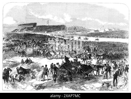 Visit of the Prince and Princess of Wales to Ireland: general view of Punchestown Races, [County Kildare], 1868. The future King Edward VII and Queen Alexandra at the races. 'The party reached the grand stand at Punchestown at twenty minutes past two. There was an immense concourse of people in carriages and on foot awaiting their arrival on the ground. The Royal party took their seats in the pavilion next to the grand stand. The Princess, as well as the Prince of Wales, took a lively interest in the proceedings. The weather was brilliantly fine, and almost sultry. The racing commenced at half Stock Photo