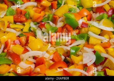 Colored pepper and onion are sliced in a bowl. salad for the winter. conservation Stock Photo