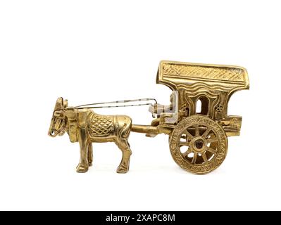 an intricately crafted antique gold model of a vintage bullock cart, used for transport and in agriculture in villages in historical times against a w Stock Photo