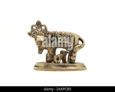 golden bronze figurine of a cow with calf isolated on a white background Stock Photo