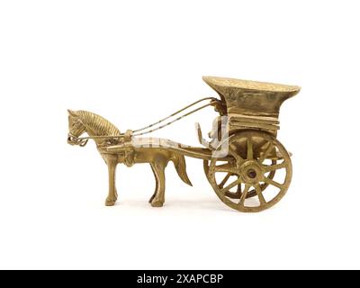 detailed antique model of a horse-drawn carriage used for transportation crafted and intricately designed in golden brass metal isolated on a white Stock Photo