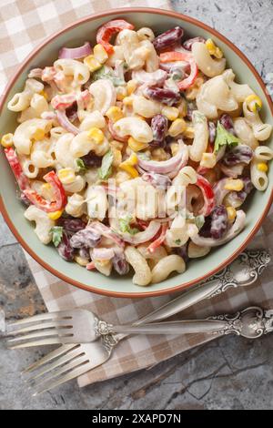 Southwestern pasta salad is a zesty summer side filled with fresh corn, onion, beans, peppers with creamy homemade ranch style dressing closeup on the Stock Photo