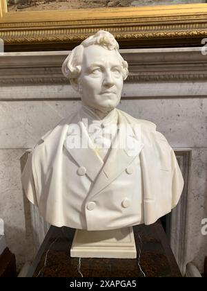 A sculpture of Thomas Holloway. Paintings in the Art Gallery at Royal Holloway in Egham, Surrey. 'Today's Royal Holloway is formed from two colleges, founded by two social pioneers, Elizabeth Jesser Reid and Thomas Holloway. They were among the first places in Britain where women could access higher education. Bedford College, in London, opened its doors in 1849, and Royal Holloway College's stunning Founder's Building was unveiled by Queen Victoria in 1886 – it’s still the focal point of the campus. In 1900, the colleges became part of the University of London and in 1985 they merged to form Stock Photo