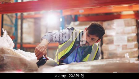 Man, package and scanner for logistics, stock and inventory management in warehouse with barcode for tracking. Industrial worker with scanning Stock Photo