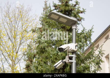 Security cameras mounted on LED lamp post Stock Photo