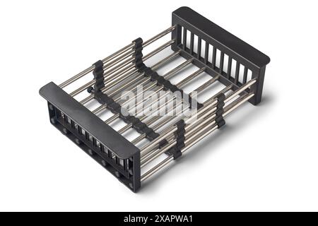 stainless steel kitchen over the sink drying rack isolated white background, retractable drain basket with adjustable armrest, cutlery and cooking Stock Photo