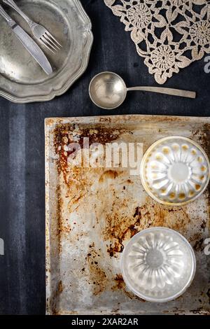 Various old kitchen objects on black chalkboard background. Flat lay. Stock Photo