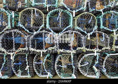 close up detail of stack of lobster pots on quayside at staithes Stock Photo