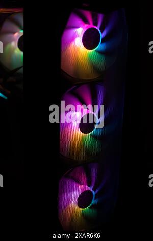 Colored fan in the computer. LED lighting in the system unit. Bright light in the fan. Computer parts. Stock Photo