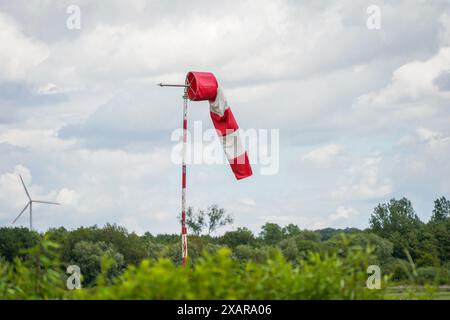 Wind Direction Indicator, Windsock, windsock, or wind cone on small plane landing strip, Schinveld, Netherlands. Stock Photo