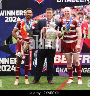 London, UK. 08th June, 2024. Man of the Match Bevan French, Wigan Warriors Head Coach Matt Peet and Captain Liam Farrell with the Challenge Cup Trophy during the Challenge Cup Final match between Warrington Wolves and Wigan Warriors at Wembley Stadium, London, England on 8 June 2024. Photo by Ken Sparks. Editorial use only, license required for commercial use. No use in betting, games or a single club/league/player publications. Credit: UK Sports Pics Ltd/Alamy Live News Stock Photo