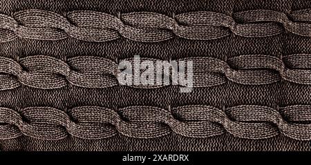 Close-up of grey knitted fabric with twists Stock Photo