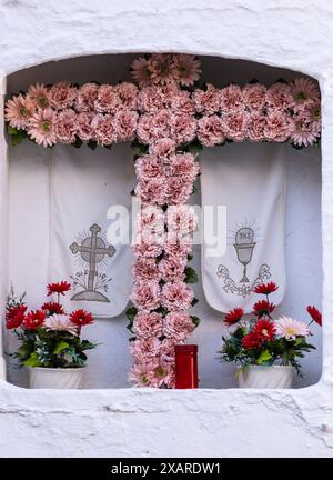 flower cross in a street chapel, Alcaudete, Jaén province, Andalusia, Spain. Stock Photo