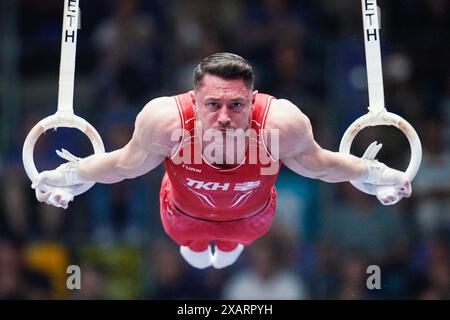 08 June 2024, Hesse, Frankfurt/Main: Gymnastics: German Championships, decisions, all-around, men, Süwag Energie Arena. Andreas Toba (TK Hannover) performs on the rings. Photo: Uwe Anspach/dpa Stock Photo