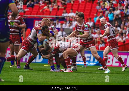 Wembley, London, UK. 8th June, 2024. Betfred Challenge Cup Final Rugby: Warrington Wolves Vs Wigan Warriors at Wembley Stadium. Rodrick Tai is tackled by Bad O'Neil & Luke Thompson. Credit James Giblin Photography/Alamy Live News. Stock Photo