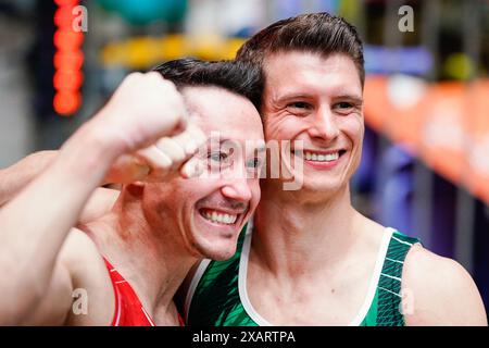 08 June 2024, Hesse, Frankfurt/Main: Gymnastics: German Championships, all-around, men, Süwag Energie Arena. The winner Lukas Dauser (r) and the runner-up Andreas Thoba are happy together. Photo: Uwe Anspach/dpa Stock Photo