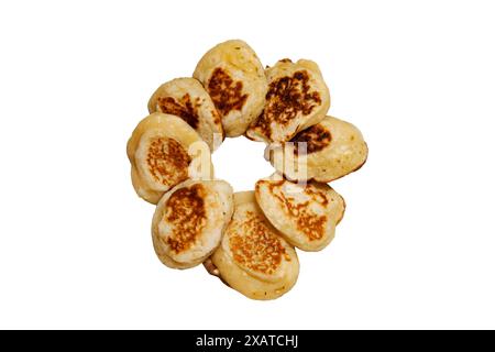 Delicious country breakfast, fried pancakes in a plate with a fork on a white background. Top view Stock Photo