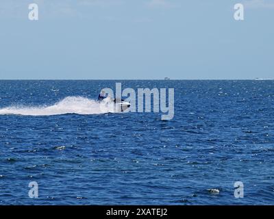 Miami, Florida, United States - April 13, 2024: Jet ski in Biscayne Bay crossing Matheson Hammock Park. Only for editorial use. Stock Photo