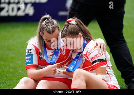 Wembley, London, UK. 8th June, 2024. Betfred Women’s Challenge Cup Final Rugby: Leeds Rhinos Women Vs St Helens Women at Wembley Stadium. Tara Jones & Vicky Whitfield looking at their winners medals. Credit James Giblin Photography/Alamy Live News. Stock Photo