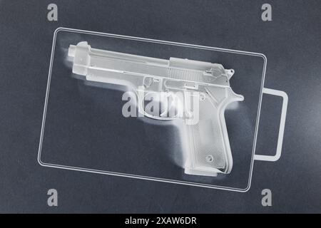 X-ray sensor view of a handgun in a carry-on bag Stock Photo