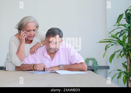 Older couple review their documents and investments Stock Photo