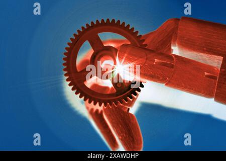 Robot hand holds a glowing gear representing tech fusion and progress, Stock Photo