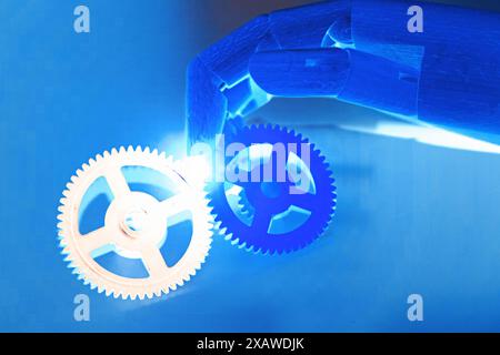 Robotics hand with gears, on blue background. Innovative industrial technology and artificial intelligence concept. 3D illustration rendering Stock Photo