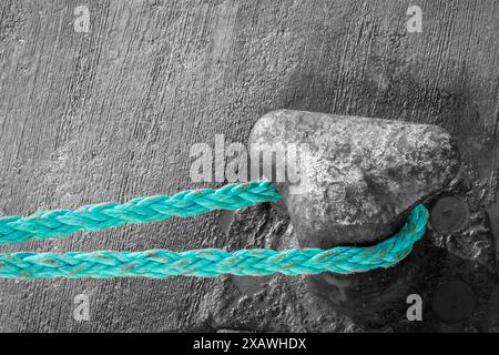 turquoise-colored rope on the beach with a black-and-white background Stock Photo