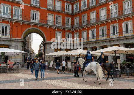 Madrid, Spain - 6 April, 2024: mounted municipal police patrolling in the Plaza Mayor city square of Madrid Stock Photo