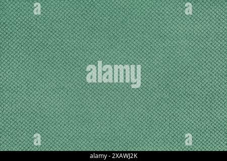 Plain green velor upholstery fabric, jacquard with fine diamond texture background. Close up, macro cloth textile surface. Wallpaper, backdrop with co Stock Photo