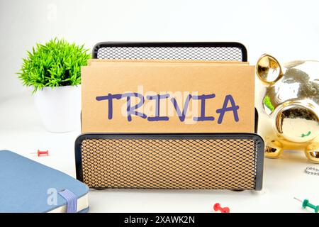 Trivia concept. Word Trivia written on the envelope in a stand in front of a white background Stock Photo