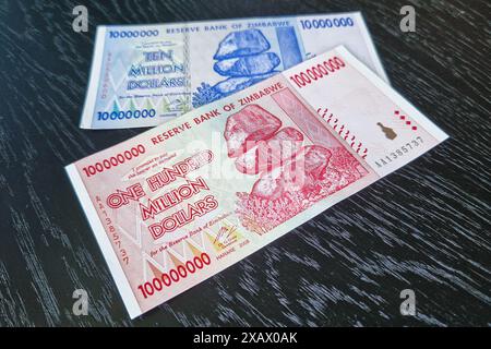 Stockholm, Sweden - May 15, 2024: One hundred million dollars and ten million dollars banknotes of Zimbabwe. Stock Photo