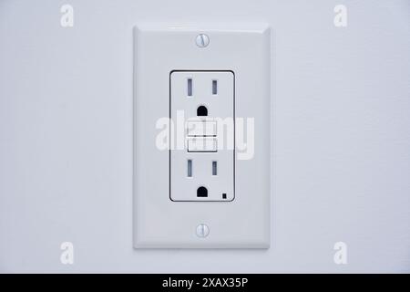 Tamper resistant GFCI Ground Fault Circuit Interrupter power outlet Stock Photo